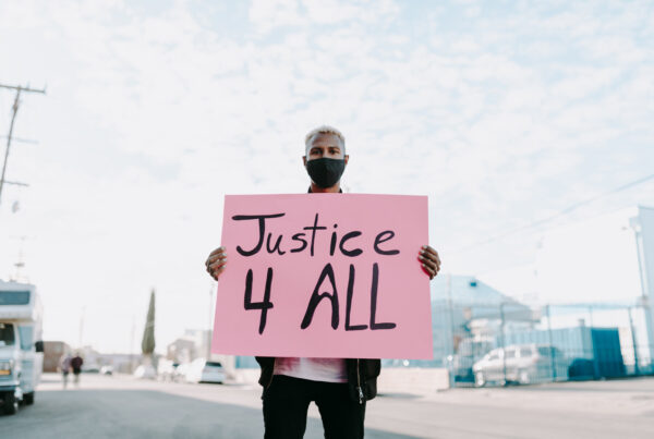 man holding sign that reads justice 4 all